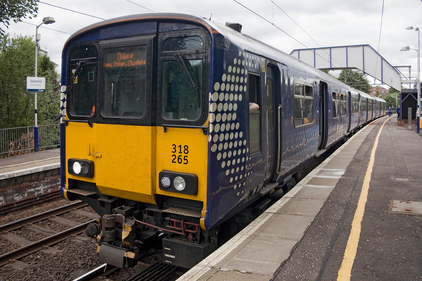 318265, SR 11.41 Springburn-Dalmuir (2F23, 2L), Jordanhill station 
 318265 is about to depart from Jordanhill station working the 11.41 Springburn to Dalmuir. Andy and I had travelled on this train from the depths of Queen Street Low Level station. These class 318s bear a striking resemblance to the diesel class 150s and were introduced in 1986 to replace many first generation DMUs. The ones wearing their smart ScotRail livery, as seen here, have had the second refurbishment of their thirty odd years' life. 
 Keywords: 318265 2F23 Jordanhill station