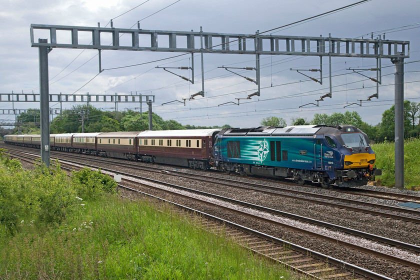 68018, 10.25 Old Oak Common-Kidderminster SVR ECS (0Z72), Ashton Road Bridge 
 As the rain clouds gather, the first of two ECS moves pass between Ashton and Roade on the southern WCML in Northamptonshire. 68018 'Vigilant' leads the 10.25 old Oak Common to Kidderminster SVR running as 0Z72. The stock was being delivered in connection with railtour duties. 
 Keywords: 68018 10.25 Old Oak Common-Kidderminster SVR ECS 0Z72 Ashton Road Bridge