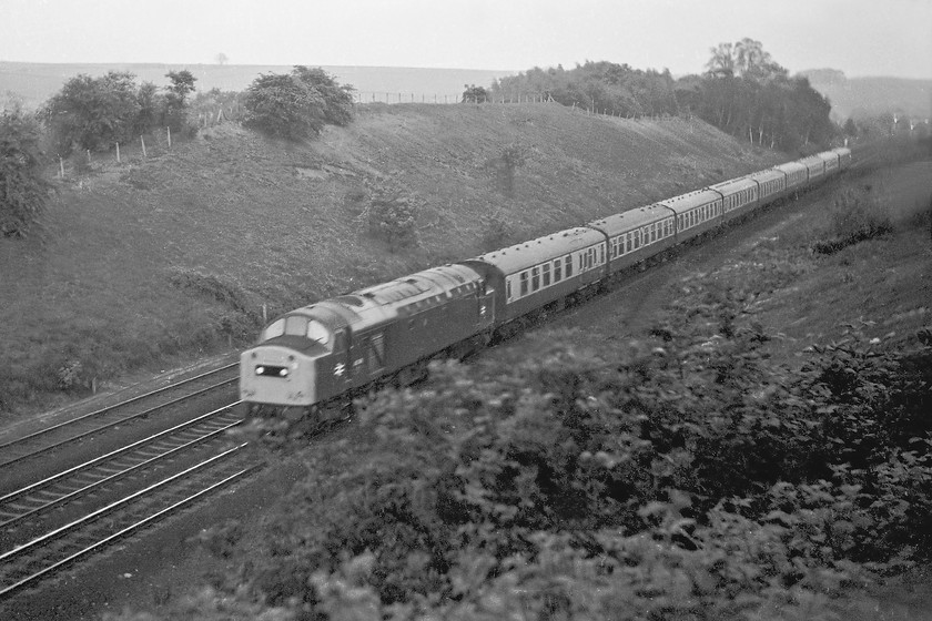 40149, unidentified down working, South Parade bridge, Grantham 
 In the dying light of this lovely early summer evening, 40149 descends Stoke Bank from South Parade Bridge just outside Grantham. I have not been able to be identify this working but it's composed a lovely uniformed set of Mk. I stock. 40149 had a just over twenty years of life on the network ending its life at Swindon in June 1986. 
 Keywords: 40149 unidentified down working South Parade bridge, Grantham