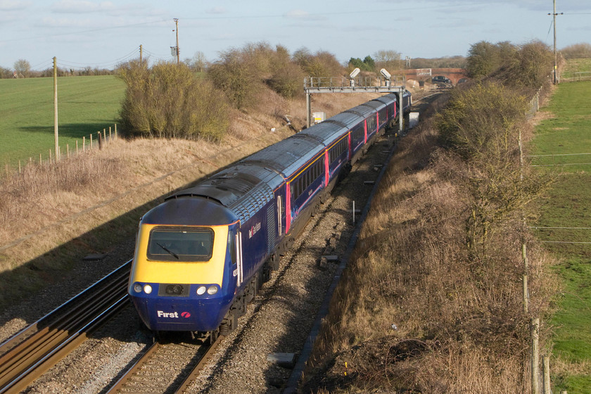 43032, GW 14.15 London Paddington-Cardiff Central (1B42), Bourton SU228874 
 Looking superb in the later afternoon winter sunshine at Bourton near Swindon, 43032 leads the 14.15 Paddington to Cardiff HST working. Notice the concrete covers over the pilings that have been dug to accommodate the electrification masts. This will mean that this superb view of the GWML will be completely ruined making this view impossible. Whilst this view looks a quiet rural one, the bridge on which I am standing is surprisingly busy for a country road and, being rather narrow, means that you have to keep your wits about you to avoid an accident! 
 Keywords: 43032 14.15 London Paddington-Cardiff Central 1B42 Bourton SU228874