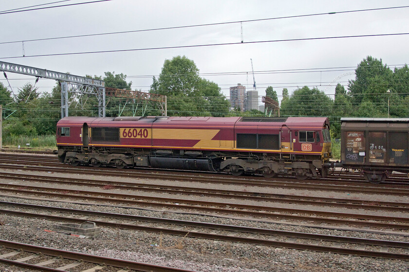 66040, 06.53 Dollands Moor-DIRFT (6M45, RT), Wembley Yard 
 At the northern end of Wembley Yard the seven-day-a-week 'water train' is seen waiting to leave and head northwards on the final leg of its journey from central Europe. 66040 is working the 6M45 06.53 Dollands Moor to Daventry that once it arrives at the Northamptonshire hub will return later in the afternoon with the empty Cargowaggons from yesterday's train. 
 Keywords: 66040 06.53 Dollands Moor-DIRFT 6M45 Wembley Yard EWS