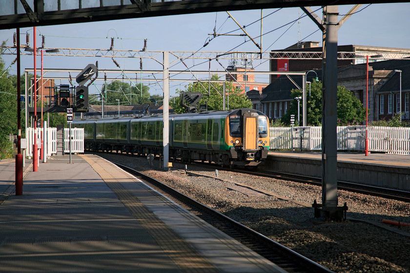 350128, LM 07.55 Crewe-London Euston (1U22, RT), Stoke-on-Trent station 
 350128 slows for its stop at Stoke with the 07.55 Crewe to London Euston. This train is a slow 'all stations' train on this part of its journey. But, once it's at Rugby it runs 'fast' to London vying for space with Pendolinos and Voyagers. 
 Keywords: 350128 1U22 Stoke-on-Trent station