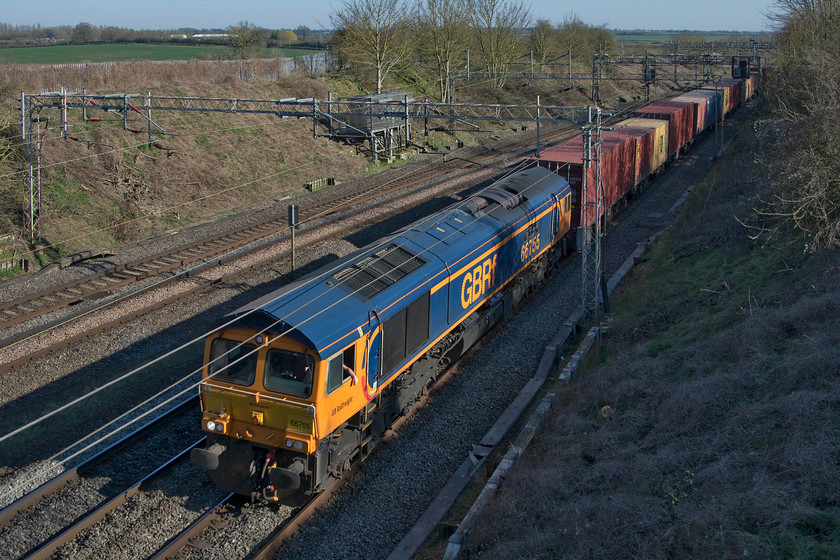 66755, 12.05 London Gateway-Hams Hall (4M46, 8E), Victoria bridge 
 Same working, same locomotive, same location and same scenario! As per Monday, see.... https://www.ontheupfast.com/p/21936chg/28936788404/x66755-12-05-london-gateway-hams the 12.05 London Gateway to Hams Hall 4M46 has been routed on the down fast line to avoid the Northampton loop. The driver nonchalantly leans with his arm out of the window of 66755 'Tony Berkeley OBE RFG Chairman 1997-2018' as it passes Victoria bridge between Rugby and Milton Keynes. 
 Keywords: 66755 12.05 London Gateway-Hams Hall 4M46 Victoria bridge GBRf Tony Berkeley OBE RFG Chairman 1997-2018