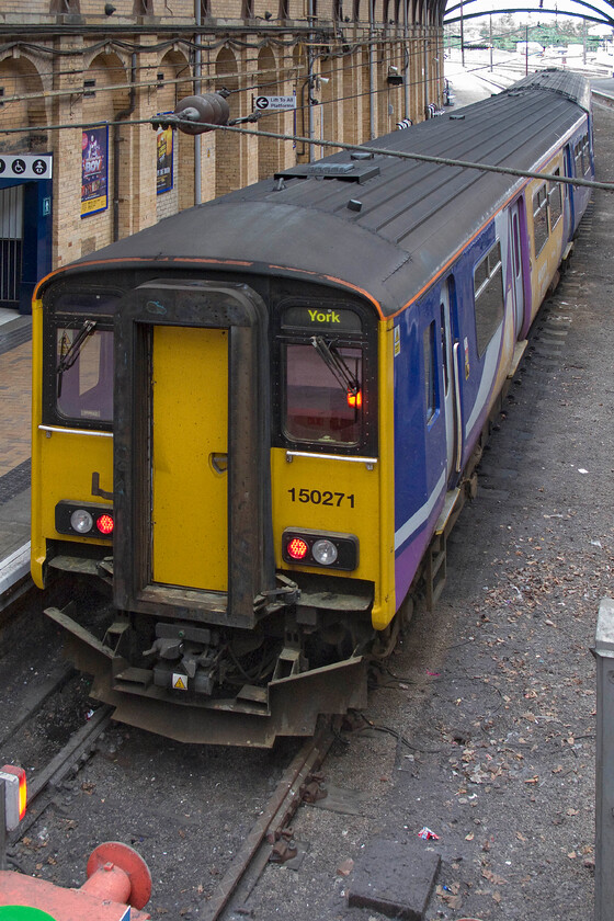 150271, NR 15.11 York-Leeds (2C41), York station 
 Taken from York station's footbridge 150271 is seen prior to working the 15.11 Northern service to Leeds via Harrogate. As a traveller on this almost circular route, I would have the choice of either a class 150, as seen here, or a nodding donkey Pacer, which one would I prefer; I am not sure? 
 Keywords: 150271 15.11 York-Leeds 2C41 York station Northern