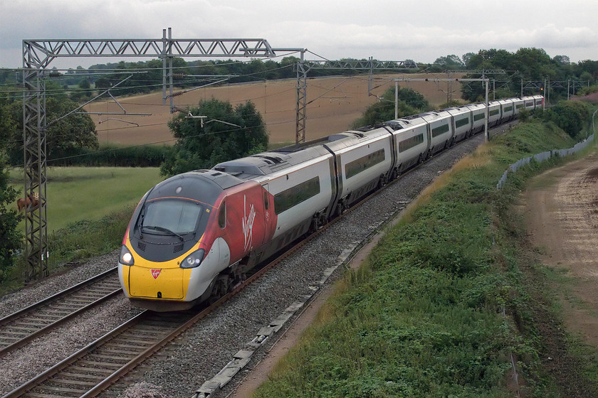 390122, VT 19.05 London Euston-Liverpool LS (1F21, 6L), Milton Crossing 
 In the poor evening light, 390122 'Penny the Pendolino' races past Milton Crossing just to the north of Roade Cutting working the 19.05 Euston to Liverpool Lime Street. 
 Keywords: 390122 19.05 London Euston-Liverpool Lime Street 1F21 Milton Crossing