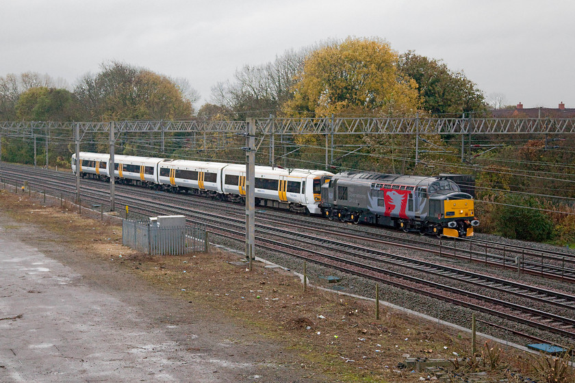 37884 & 375906, 14.13 Wembley-Derby Litchurch Lane ECS drag, site of Roade station 
 Rail Operations Group's 37884 leads a Southeastern Electrostar 375906 from Wembley yard to Derby Litchurch Lane for refurbishment. The entire fleet are being so treated with the programme commencing last year in 2015. They are emerging from the Bombardier plant in Derby in their new dark blue livery. The train is seen passing the site of Roade station on the down fast. 
 Keywords: 37884 375906 14.13 Wembley-Derby Litchurch Lane ECS site of Roade station