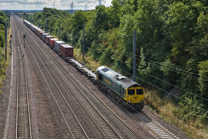 66593, 06.14 Felixstowe North-Leeds FLT (4E22), Westby SK 962271 
 A comparison with .... https://www.ontheupfast.com/p/21936chg/25410359604/x55017-15-00-london-kings-cross-aberdeen reveals a very similar scene apart from the inevitable lineside growth blighting the embankments of our modern railway! 66593 huls the 06.14 Felsixtowe North to Leeds FLT Freightliner service near Westby now down to walking pace. It was to be held at a red signal preventing it from rejoining the down fast whilst various express services passed. 
 Keywords: 66593 06.14 Felixstowe North-Leeds FLT 4E22 Westby SK 962271 Freightliner