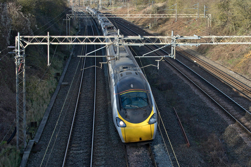 390008, VT 11.13 Manchester Piccadilly-London Euston (1A20, 4E), Victoria bridge 
 390008 takes the last of the sharp curves on the route it has just taken from Rugby to here at Roade. From here on south to Euston it's a much straighter route and at least four track all the way. The plain liveried Avanti West Coast Pendolino is working the 11.13 Manchester Piccadilly to Euston service. 
 Keywords: 390008 11.13 Manchester Piccadilly-London Euston 1A20 Victoria bridge Avanti West Coast Pendolino