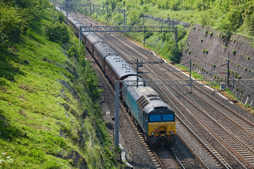 57314, outward leg of The Canterbury Tales Express, 05.29 Skipton-Dover (1Z80), Roade cutting 
 The 'going-away' shot of the 05.29 Skipton to Dover Canterbury Tales charter is rather backlit as it passes through Roade cutting. However, it is worthwhile as I have few images of the ATW-painted Class 57s that have now been replaced by Class 67s. Still wearing its ATW paint scheme but minus any branding, former Virgin Thunderbird 57314 (ex 'Firefly'), brings up the rear of the charter. I was hopeful that later in the day I would capture the train returning with 57314 leading....we will see! 
 Keywords: 57314 The Canterbury Tales Express 05.29 Skipton-Dover 1Z80 Roade cutting Firefly