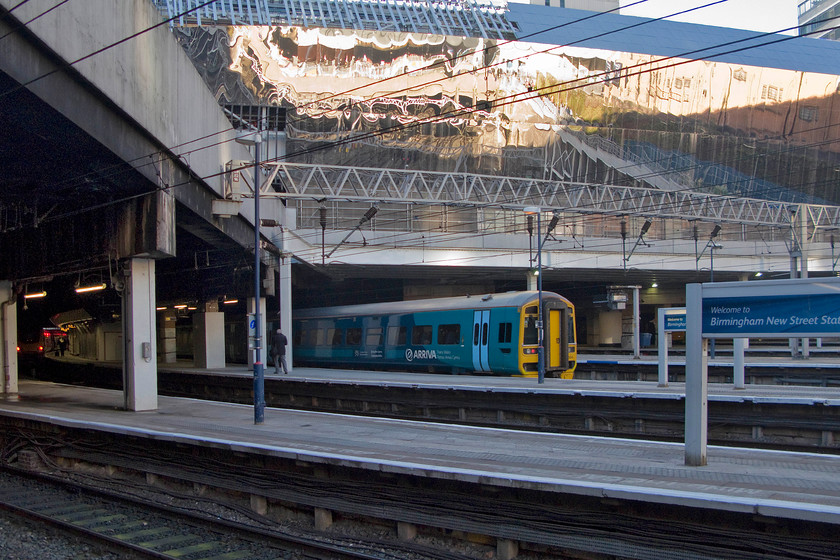 158834, AW 16.09 Birmingham International-Aberystwyth (1J23), Birmingham New Street station 
 The rear of ATW's 16.09 Birmingham International to Aberystwyth formed by 158838 pokes out from the dark confines of New Street station. This service was composed of two units with the train splitting at Machynlleth. Notice the new stainless steel cladding being applied to the rebuilt station building. 
 Keywords: 158834 16.09 Birmingham International-Aberystwyth 1J23 Birmingham New Street station