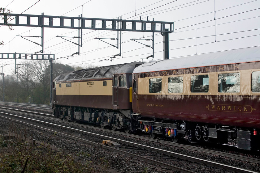 57601, outward leg of The Northern Belle, 06.47 London Euston-Liverpool South Parkway (1Z59), Ashton Road bridge 
 In its dedicated Northern Belle livery the West Coast Railways livery, 57601 'Windsor Castle' brings up the rear of The Northern Belle stock running as the 06.47 Euston to Liverpool South Parkway. It was carrying punters on their way to the Grand National, a race dominated by Tiger Roll at 4:1. Just an observation, when the 57 was painted, why was the cream strip on the side not applied to be the same width as that of those on the stock? 
 Keywords: 57601 The Northern Belle 06.47 London Euston-Liverpool South Parkway 1Z59 Ashton Road bridge