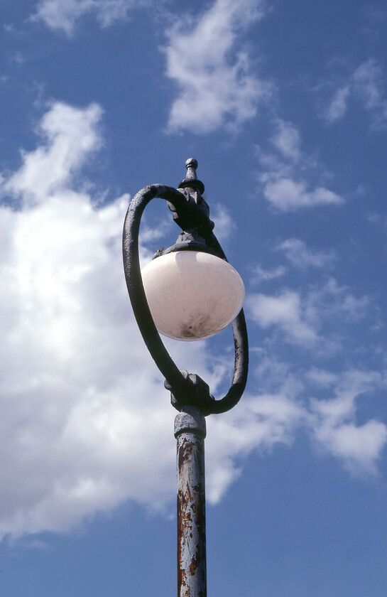 LNER globe lamp, footbridge, March West Junction 
 Globe lamps were a notable feature of LNER passenger interface infrastructure that was once very commonplace. By 1981 most had been swept away but one did occasionally come across them as here on a footbridge at March West Junction. I also managed to capture some six months or so previously on New Holland Pier, see.... https://www.ontheupfast.com/p/21936chg/29820618204/lner-globe-enamel-new-holland-pier 
 Keywords: LNER globe lamp footbridge March West Junction