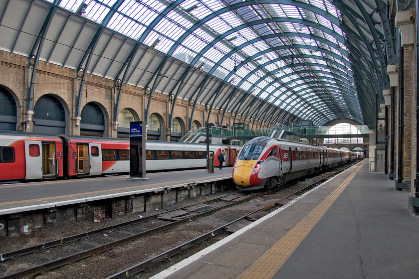 Class 800, GR 16.35 London King`s Cross-Leeds (1D22, 1E), London King`s Cross station 
 Inside the grandeur of King's Cross' trainshed, two LNER services are seen. By way of comparison, the five-car class 800 Azuma looks positively short compared to the Mk. IV set in the adjacent platform. The generous room and relative comfort of the older stock will be missed when they are finally withdrawn from east coast operation over the coming couple of months. 
 Keywords: Class 800 16.35 London King`s Cross-Leeds 1D22 London King`s Cross station Azuma LNER