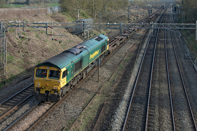 66515, 09.31 Felixstowe-Ditton (4M88), Victoria bridge 
 Such are the times that we are now living in I had great difficulty in identifying this working having to rely on my spotting companion Mike who has some access to TOPS via Freightmaster. 66515 heads past Victoria bridge between Northampton and Milton Keynes with the 4M88 09.31 Felixstowe to Ditton. As can be seen in this image, this northbound service was empty apart from just two boxes approximately halfway along the length of the train. 
 Keywords: 66515 Victoria bridge 09.31 Felixstowe-Ditton 4M88