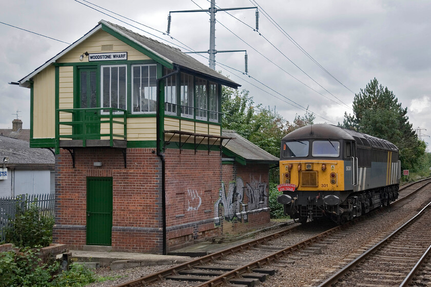 56301, running round, Peterborough Nene Valley station 
 A second photograph of 56301 as it runs round at Peterborough Nene Valley station from where it will then lead the 12.10 return service to Wansford that I would travel on to enjoy some 'Grid action'! The locomotive has just drawn past the mysteriously named Woodstone Wharf signal box. This box was formally located at Welland Bridge in Spalding but is unrecognisable from when I photographed it back in 1981, see..... https://www.ontheupfast.com/p/21936chg/30047000102/welland-bridge-signal-box-ge-great 
 Keywords: 56301 Peterborough Nene Valley station Fastline Grid