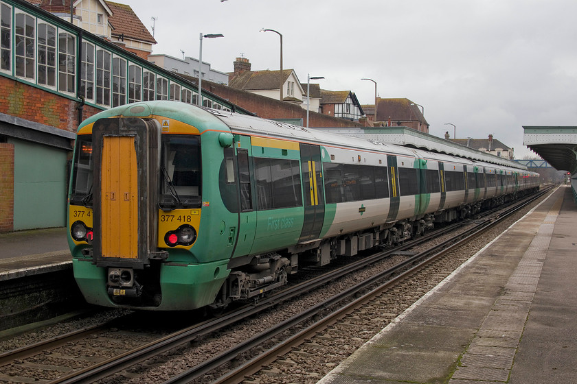 377418, SN 13.18 Ore-Brighton (1F45, RT), Bexhill station 
 Southern's 377418 pauses at Bexhill station working the 13.18 Ore to Brighton service. I was a little disappointed with Bexhill station, it was a bit dowdy but was undergoing a re-paint that would improve matters somewhat. It was also a bit of a surprise to witness a trio of youths smoking marijuana sitting on the wall out at the front of the station next to the parked van; I thought that Bexhill was a haven for retirees! 
 Keywords: 377418 13.18 Ore-Brighton 1F45 Bexhill station