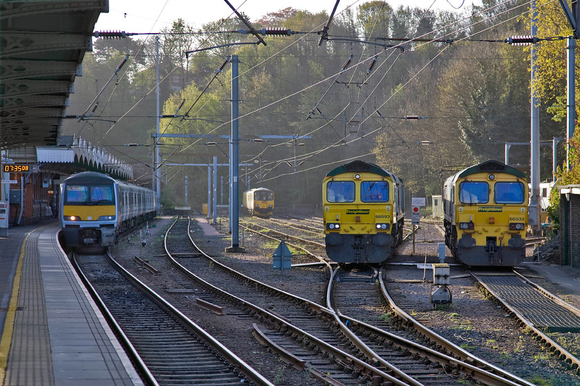 321328, 950001, 66593 & 66532, stabled, Ipswich station 
 Ipswich's small and compact yard is a busy place that fuels and undertakes basic maintenance on locomotives that are involved in the constant flow of freight to and from the nearby Port of Felixstowe. On this particular day, along with 90041 (almost obscured at the back), 66593 '3MG Mersey Multimodal Gateway' is seen next to 66532 'P&O Nedlloyd Atlas'. In the background is Network Rail's track recording train in the form of 950001 that would follow us throughout the morning. Finally, standing at platform four is 321328 stabled awaiting its next service to Liverpool Street. 
 Keywords: 321328 950001 66593 66532 stabled Ipswich station Freightliner Abellio Greater Anglia P&O Nedlloyd Atlas 3MG Mersey Multimodal Gateway