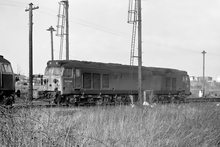 50044, stabled, Westbury MPD 
 It was not uncommon to find a Class 50 on Westbury shed but it was not a regular occurrence. They usually ended up there as a result of a problem when they operating a west of England express being removed from the train and deposited until either a local repair could be undertaken or until they could be moved to Laira or Old Oak Common. Here, 50044 'Exeter' sits in Westbury yard with a class 47 just putting in an appearance to the left. 
 Keywords: 50044 Westbury MPD