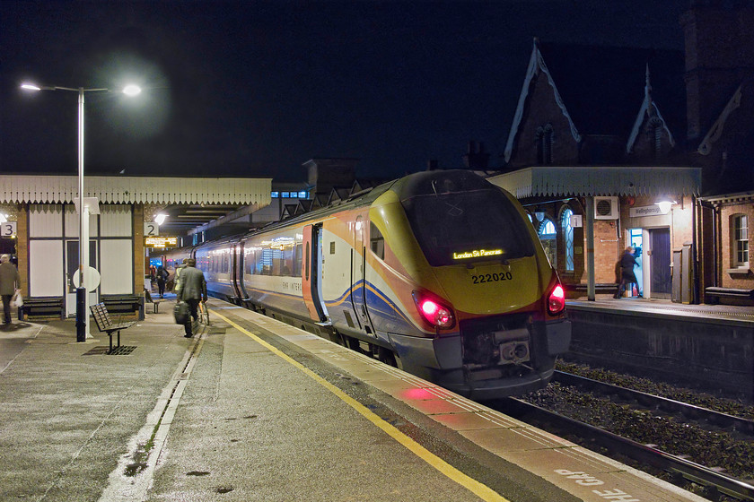 222020, EM18.12 Nottingham-London St. Pancras (1B72, 7L), Wellingborough station 
 East Midlands Railway's 222020 pauses at Wellingborough station with the 18.12 Nottingham to London St. Pancras. There are no electrification masts in this view but I suspect that this will change as there is one just behind the footbridge and one just behind my right shoulder. This gap is too long for the wiring so, according to my back of a fag packet calculations, the mast should go right through the Midland station canopies on the up and down platforms in the middle of this view. We will see what solution the engineers will come up with! 
 Keywords: 222020 18.12 Nottingham-London St. Pancras 1B72 Wellingborough station