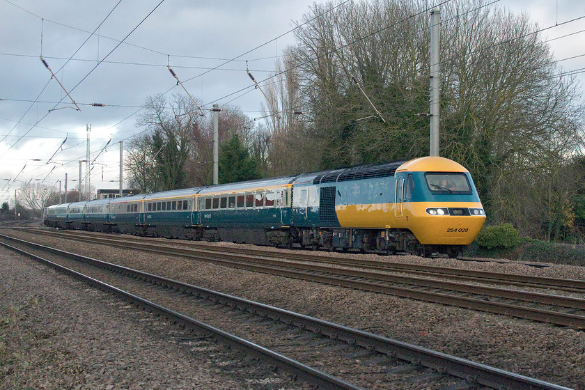 43112 & 43006, final leg of Let`s go Round Again, 11.01 Leeds-London King`s Cross (1Z43), Gill`s Crossing 
 Specially repainted for the occasion by the teams at Craigentinny and Doncaster depots, HST set EC56 with power cars 43112 and 43206 look absolutely superb as they operate the final leg of the charity Let's go Round Again four-day tour of the routes formally operated by East Coast HSTs. This final leg, running as the 1Z43 11.01 Leeds to King's Cross, is seen on the up slow line passing Offord Cluny just south of Huntingdon. It passed with a crescendo of horn blowing and, as can be seen, a crowded cab! A bit of renumbering added to the authenticity of the event with the front power car in this image, 43312 running with its original number E43112 with the correct set number 254029 applied to the front end. The rear power car was an early Western Region power car from 253003 that carried W43003, as an LNER unit it was numbered 43206 for many years. 
 Keywords: 43112 43006, final leg of Let`s go Round Again 11.01 Leeds-London King`s Cross 1Z43 Gill`s Crossing HST farwell Flying banana Offord Clunny ECML