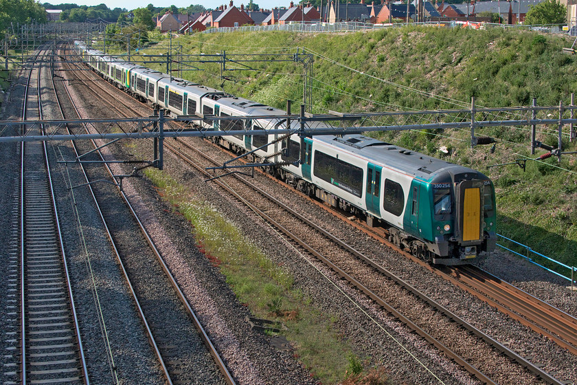 350254, 350246 & 350235, LN 17.02 Northampton-London Euston (2N46, 7L), Ashton Road bridge 
 A trio of London Northwestern Desiros pass Roade, seen in the background, and are about to pass under Ashton Road bridge with the Sunday afternoon 17.02 Northampton to Euston 2N46 service. Don't turn up at this location to take photographs of either north or southbound trains unless in possession of a ladder as without one it is all but impossible due to very high parapets - that is unless your camera has a flip-out screen and you have long arms! 
 Keywords: 350254 350246 350235 17.02 Northampton-London Euston 2N46 Ashton Road bridge London North Western Desiro