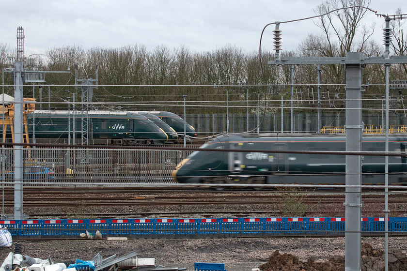 800315, stabled & 800004, GW 15.41 Bedwyn-London Paddington (1K23, 2L), Old Oak Common 
 In the gathering afternoon gloom at Old Oak Common, 800004 speeds eastwards with the 15.41 Bedwyn to Paddington service now within two miles of its destination. The IET is passing three further units, with only 800315 identifiable, that are stabled at the former HS1 North Pole depot. Just before this train passed we had been observing a fox skulking about on the tracks in the foreground that seemed totally unphased by the passing of the trains and living cheek by jowl with the vast HS2 building work taking place all around it! 
 Keywords: 800315 800004 15.41 Bedwyn-London Paddington 1K23 Old Oak Common Great Western Railway IET