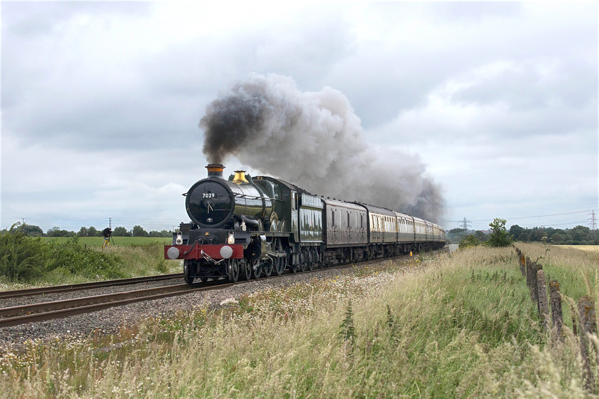 7029, outward leg of the Oxford 175 Luncheon Circular, 12.38 Oxford Parkway-Princes Risborough (1Z70), Radley SP527002 
 The driver and fireman of 7029 'Clun Castle' were working the locomotive hard as it left Oxford; we could see the exhaust for some distance and, I for one, thought the driver was bound to shut-off before it got to us here in a field just north of Radley. However, as can be seen, this was not the case and the train was kept under power until it passed Radley station where other photographers stated that there was little exhaust! The Castle is leading the outward leg of the Oxford 175 Luncheon Circular to celebrate the opening of the railway at this actual location in 1844. Passengers were treated to this run to Didcot, then a dash along the GWML to Greenford, a nip around to South Ruislip and finally a run back along the Chiltern Line to Princes Risborough. 
 Keywords: 7029 Oxford 175 Luncheon Circular 12.38 Oxford Parkway-Princes Risborough 1Z70 Radley SP527002