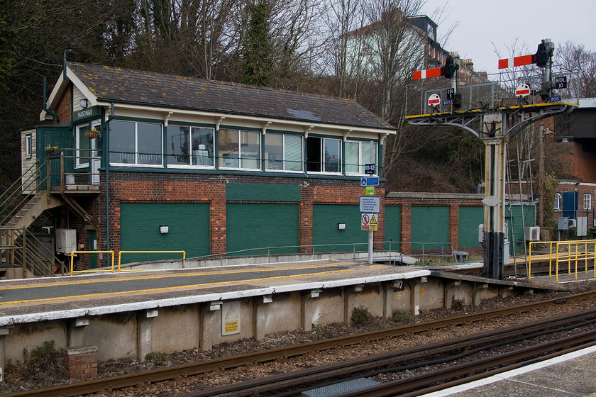 Hastings signal box (SR, 1930) 
 Hastings signal box and one of the down starter brackets complete with shunting signals. The box is the first type of the Southern's standard designs and was constructed in 1930. Unusually, all the lines it controls are designated as 'down' due to the nomenclature permitting the direction (from London) being via Tunbridge Wells or Ashford. It's a busy box, with nearly all of its 84 levers still in use. 
 Keywords: Hastings signal box