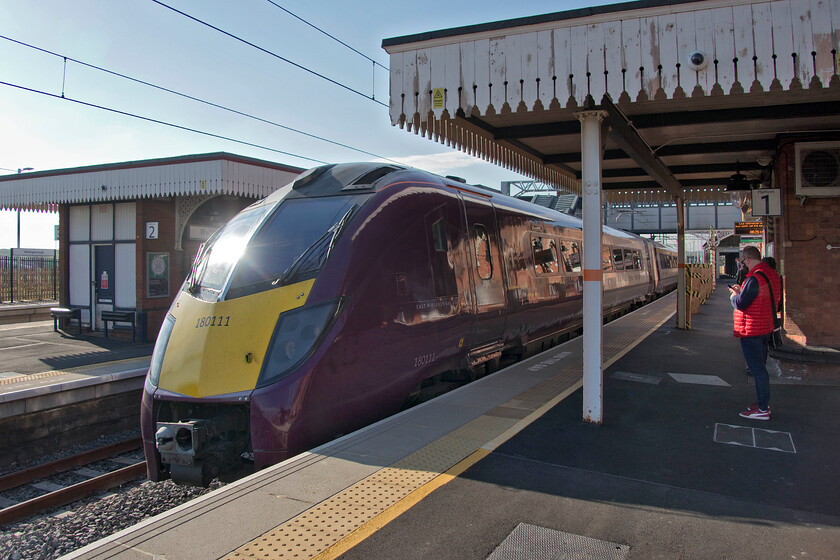 180111, EM 07.35 London St. Pancras-Nottingham (1D09, 6L), Wellingborough station 
 180111 arrives into Wellingborough station working the 07.35 St. Pancras to Nottingham EMR train. We took this service to its destination as the first part of our journey to Yorkshire. Whilst the exterior of the train has been repainted into EMR's house colours the interior could not hide its previous operator's identity (Grand Central) with pictures of East Yorkshire adorning the toilets! 
 Keywords: 180111 07.35 London St. Pancras-Nottingham 1D09 Wellingborough station EMR East Midlands Raiway