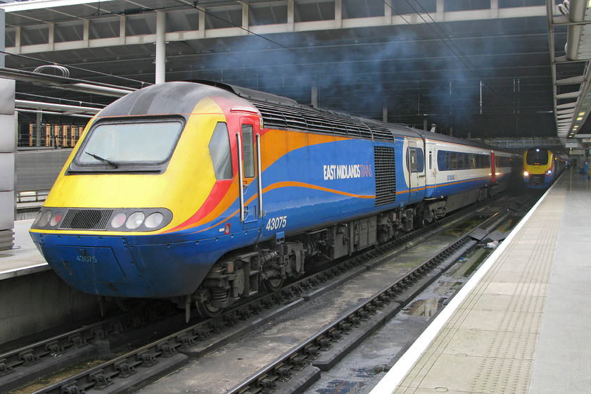 43075, EM 13.32 Nottingham-London St. Pancras (1B48) & 222003, EM 15.26 London St. Pancras-Sheffield (1F48), London St 
 With a rather smokey engine, it's a good job that 43075, the rear power car of the 1B48 13.32 from Nottingham is extending beyond the canopy of London St. Pancras' Midland station. Tucked inside the station under the canopy is 222003 'Tornado' that will work the 15.26 to Sheffield. 
 Keywords: 43075 13.32 Nottingham-London St. Pancras 1B48 222003 15.26 London St. Pancras-Sheffield 1F48 London St. Pancras station HST Meridian East Midlands Trains