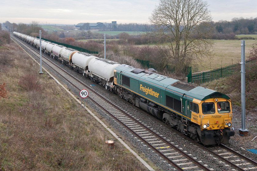 66617, 05.29 Tunstead-West Thurrock Sidings (6L44), Glendon Iron Coys bridge SP854823 
 My first picture of this Freightliner locomotive, 66617! It is seen passing Glendon East with the 6L44 05.29 Tunstead to Thurrock cement empties. Since I last visited this spot, it has undergone a fairly major transformation with more to come. The second line has been installed and to enable more trains to run to and from Corby without conflicting with each other. Also, the electrification masts have started to go in. Unfortunately, palisade fencing has spoilt the many possibilities that used to exist here for taking interesting pictures. 
 Keywords: 66617 05.29 Tunstead-West Thurrock Sidings 6L44 Glendon Iron Coys bridge SP854823