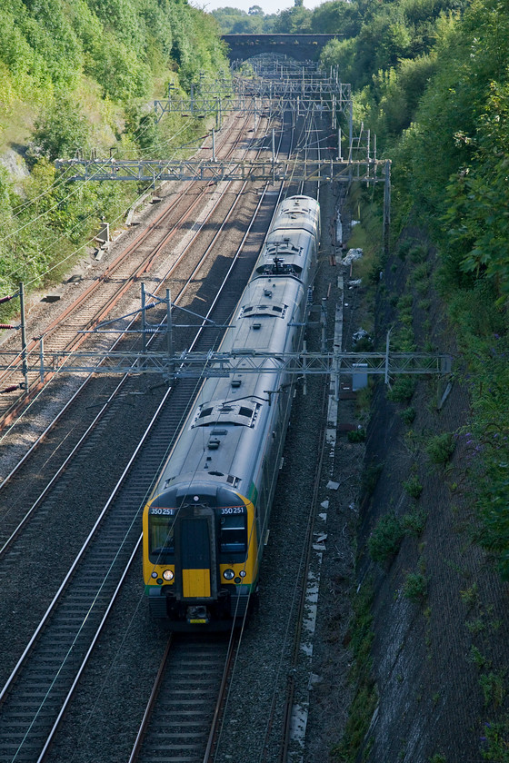 350251, LM 14.46 London Euston-Crewe (1U39, RT), Roade Cutting 
 350251 takes the down fast through Roade Cutting working the 14.46 Euston to Crewe. Unfortunately, by this time in the afternoon this side of the cutting is in total shade. 
 Keywords: 350251 1U39 Roade Cutting