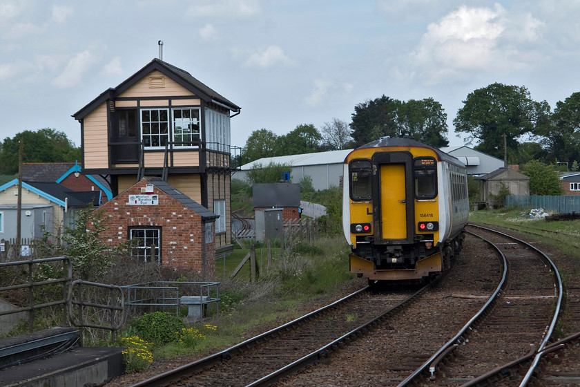 156418, LE 12.45 Norwich-Sheringham (2S18, 2L), Hoverton & Wroxham station 
 Great Anglia 156418 leaves Hoverton and Wroxham station forming the 12.45 Norwich to Sheringham. To the left is the preserved Wroham signal box that was closed by Railtrack in 2000. This impressive 1900 Great Eastern box has undergone extensive restoration and visitors are welcome to visit it for free on Sundays during the high season. Even though this picture shows the box in, what appears to be, its correct location it is in fact now five metres further way from the 'line that it was when operational. Due to siting issues of the down starter it was either to be demolished or moved; I am glad that the latter prevailed. 
 Keywords: 156418 2S18 Hoverton & Wroxham station