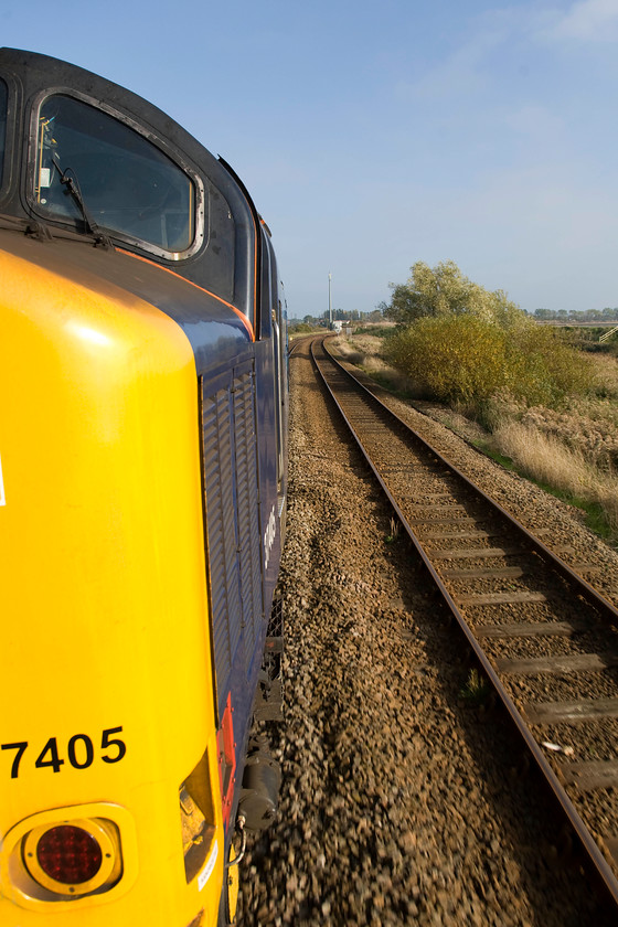 37405, LE 12.36 Norwich-Great Yarmouth (2P20), between Acle & Great Yarmouth 
 On a glorious autumn day, a spot of window leaning and a class 37 at full chat, what could be better? Taken from the leading droplight 37405 hauls the 12.36 Norwich to Great Yarmouth GA service across the Norfolk Broads between Acle and Great Yarmouth.

An audio recording of this train storming away from Brundall a little before this particular photograph was taken can be enjoyed at..... https://youtu.be/jTzQnf0ToxY ....turn it up nice and loud but check the neighbours aren't in! 
 Keywords: 37405 12.36 Norwich-Great Yarmouth 2P20 between Acle & Great Yarmouth