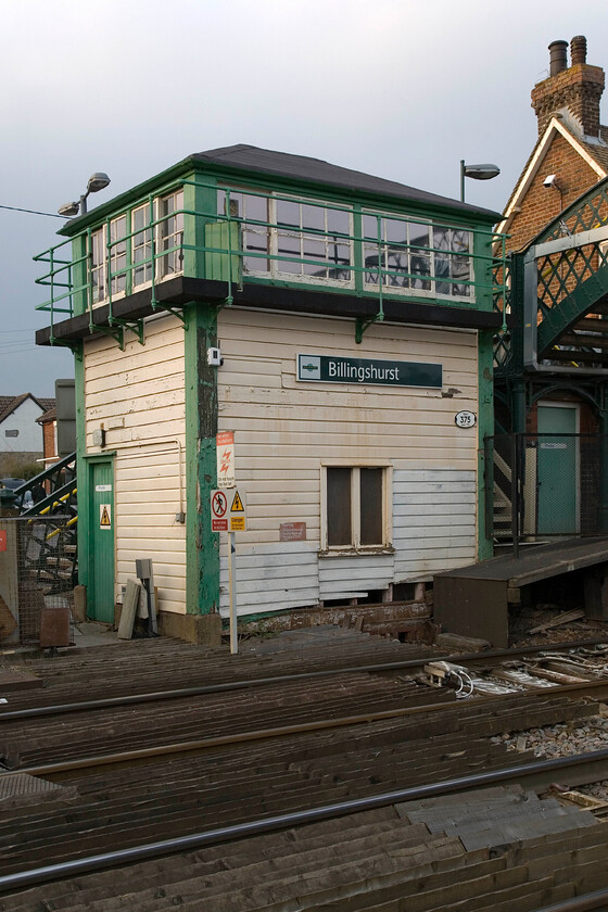 Billingshurst signal box (LBSC, 1876) 
 Billingshurst signal box is an early example of a London, Brighton and South Coast Railway Type 1B built in 1876. It is a Grade II listed structure so its future is assured when the line is resignaled in the next year or so. Its windows facing towards the station are partially obscured by the footbridge that was a later addition not helping the sighting of the signalman!

PS The box was saved following closure a year after this photograph was taken and re-erected at the Amberley Museum after extensive repairs were undertaken particularly to the staircase area (added 06.24) 
 Keywords: Billingshurst signal box LBSC, 1876