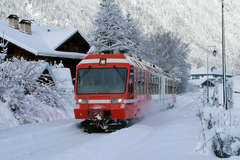 Z803, 11.38 Vallorcine-St.-Gervais-Le-Fayet (18914), Chemin des Cristalliers, Place-de-la-Gare-foot crossing, Chamonix 
 Dubbed, The Mont Blanc Express line, the one-metre line that starts at the French station of St Gervais/Le Fayet, with a steep climb to the Chamonix valley, all the way through Chamonix and Argentiere, under the Col des Montets and down the other side into Martigny in Switzerland. Taken from a small foot crossing in Chamonix, two-car Z803 slows for its stop at the station with the 11.38 Vallorcine to St.-Gervais/Le-Faye. Despite seep snow and extreme cold, the trains that use third rail pick up still operate! 
 Keywords: Z803 11.38 Vallorcine-St.-Gervais-Le-Fayet 18914 Chemin des Cristalliers Place-de-la-Gare-foot crossing Chamonix