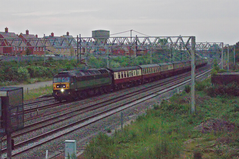 D1935, 18.17 Southall Loco Services-Crewe HS (5Z62, 21E), site of Roade station 
 What with a frustrating delay (signalling failure) at Milton Keynes and the sky completely clouding over after what had been a really nice day I almost gave up and went back home but I like a challenge! Approaching 21.00 the light has all but gone but as I had made the effort to come out I set the camera's iso to maximum and pressed the shutter! The photograph, which needed a fair bit of Photoshop work, shows D1935 (47805) Roger Hoskings MA' leading the 5Z62 18.17 Southall Loco Services to Crewe HS empty stock. This was the stock used in yesterday's Flying Scotsman charter. 
 Keywords: D1935 18.17 Southall Loco Services-Crewe HS 5Z62 site of Roade station Roger Hoskings MA LNWR Heritage