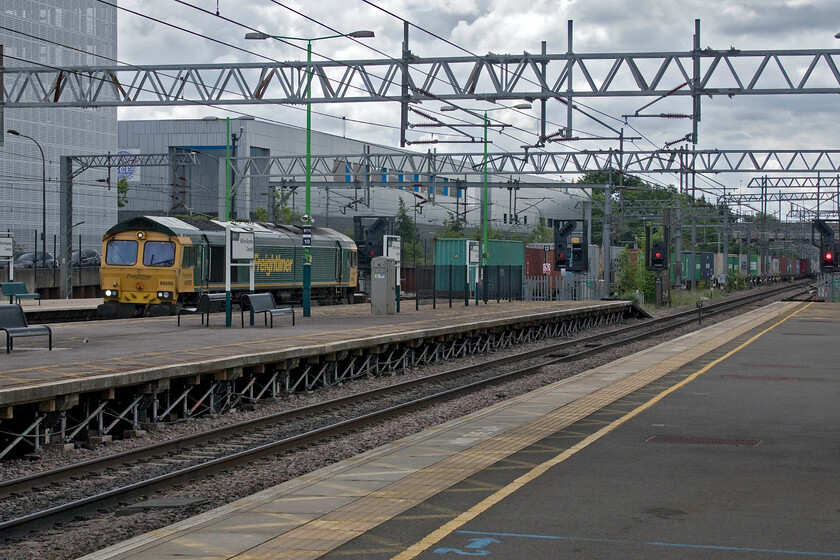 66590, 07.50 Felixstowe North-Lawley Street (4M94, 7E), Milton Keynes Central station 
 Another example of the difficulties of photographing trains at Milton Keynes station! 66590 passes at speed through the station working the 07.50 Felixstowe North to Lawley Street 4M94 Freightliner. I took this as our rain north was arriving at platform six behind where I am standing. It took us until we had got to Hanslope Junction, some six miles north, until we overhauled the freight. 
 Keywords: 66590 07.50 Felixstowe North-Lawley Street 4M94 Milton Keynes Central station Freightliner