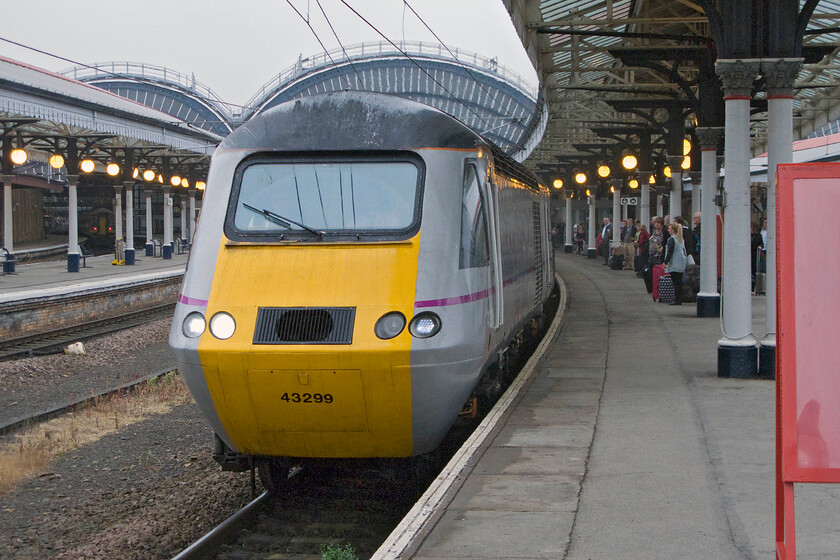 43299, GR 06.26 Edinburgh Waverley-London King's Cross (1E03), York station 
 43299 pauses at York station working the 06.26 Edinburgh to King's Cross 1E03 service. By way of a comparison, I took a photograph standing in a very similar position EXACTLY thirty-five years to the day, see ........ https://www.ontheupfast.com/p/21936chg/25366325804/x55003-unidentified-edinburgh-london However, back in 1979 the motive power was a little different as was the weather! 
 Keywords: 43299 06.26 Edinburgh Waverley-London King's Cross 1E03 York station East Coast HST