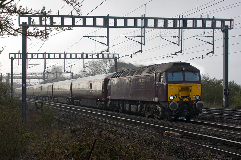 57313 outward leg of Northern Belle 06.47 London Euston-Liverpool South Parkway (1Z59), Ashton Road bridge 
 57313 leads a smart set of Northern Belle stock between Ashton and Roade on the southern WCML that is full of race-goers on their way to Aintree. Unfortunately, due to through trains not being able to get as far as the racecourse station anymore, excursions can only go as far as other Merseyside stations for onward transit to the course itself. In the case of this special, it ran as 1Z59 06.47 Euston to Liverpool South Parkway. The punters would then transfer to Merseyrail trains to get them to their destination. I hope that they were treated better than we were by awful Merseyrail staff when they made a similar change at South Parkway station last year. 
 Keywords: 57313 The Northern Belle 06.47 London Euston-Liverpool South Parkway 1Z59 Ashton Road bridge