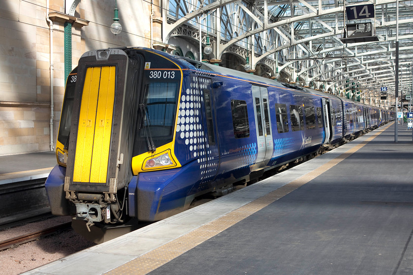 380013, SR 11.04 Glasgow Central-Ayr (2K71), Glasgow Central station 
 In lovely spring sunshine, 380013 waits at Glasgow Central's platform 14 to work the 2K71 11.04 to Ayr. My boss and I took this train as far as Prestwick Town. This was my first experience of these relatively new units. Whilst I appreciated their rapid acceleration and wi-fi facilities the ride was not very impressive. It could have been the track in the south west suburbs of Glasgow but there was a kind of 'hunting' feeling? 
 Keywords: 380013 11.04 Glasgow Central-Ayr 2K71 Glasgow Central station