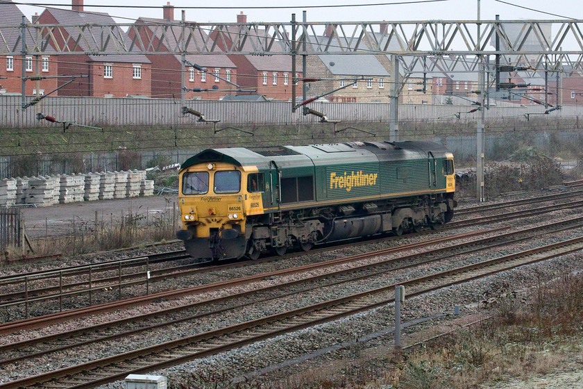 66526, 12.33 Wembley reception-Crewe Basford Hall (0Z48), site of Roade station 
 66526 'Driver Steve Dunn (George)' runs light engine past the site of Roade's former station as the 0Z48 12.33 Wembley to Crewe Basford Hall. I am not absolutely sure as to why this locomotive was making this move as it ran up, also as a light engine, from Crewe earlier in the morning as 0Z47. Close examination of the photograph reveals at least two members of staff in the cab so perhaps it was some sort of driver training turn - appropriately distanced I hope? 
 Keywords: 66526 12.33 Wembley reception-Crewe Basford Hall 0Z48 site of Roade station light engine Freightliner Driver Steve Dunn (George)