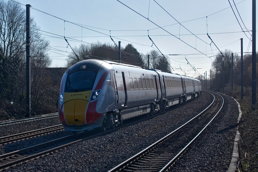 801201, GR 12.33 London King's Cross-Leeds (1D14, 9L), Arlesey station 
 Taking the cambered and curved track to the south of Arlesey station 801201 passes at speed with the 12.33 King's Cross to Leeds service. The Canon G1X camera used to take this image is a super and compact piece of kit for railway photography but its Achilles heel is its maximum shutter speed of 1/2000 sec. When a fast train is passing and when close to it as seen here there is always going to be a little motion blur. Whilst not always visible on this site close inspection reveals its presence. 
 Keywords: 801201 12.33 London King's Cross-Leeds 1D14 Arlesey station LNER Azuma