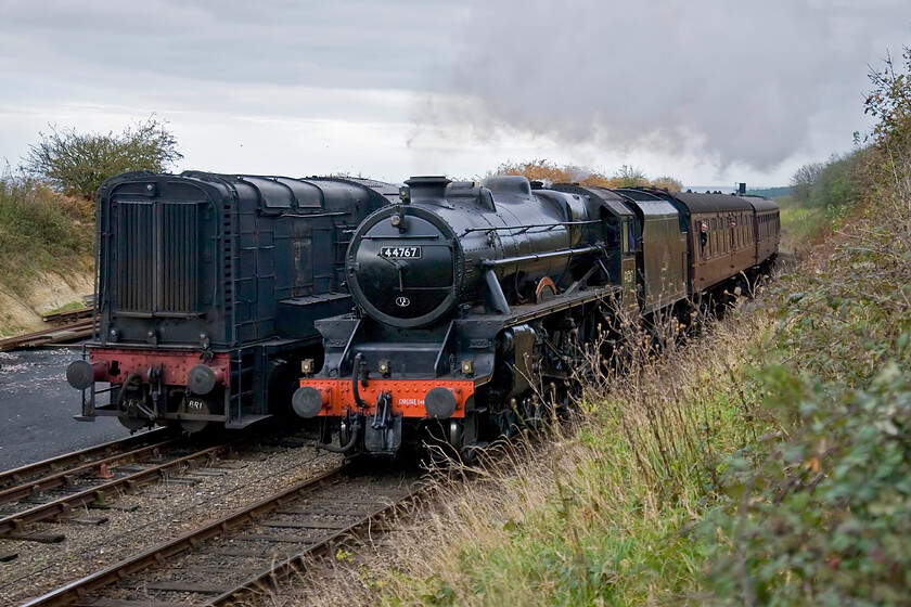 44767, 15.00 Sheringham-Holt & 12131, Weybourne yard 
 Having had its dining train cars removed at Sheringham Black 5 44767 'George Stephenson' leads the final country bound locomotive hauled service of the day into Weybourne. The 15.00 Sheringham to Holt will then return to Sheringham for the last time on this day. The train is passing one of the North Norfolk Railway's resident shunters 12131 that dates from 1952 working throughout its life on the Eastern Region until moving to Kent's Snowdown colliery near Dover from where it entered preservation in 1982. 
 Keywords: 44767 15.00 Sheringham-Holt 12131 Weybourne yard Black 5 George Stephenson