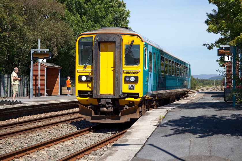 153327, AW 09.14 Crewe-Swansea (2V08), Llangennech station 
 Andy watches ATW's 153327 pass through Llangennech station working the 09.14 Crewe to Swansea. This train will travel as far as Llanelli and then reverse to complete its journey to Swansea. Llangennech station is at lovely and very quiet spot down on the Loughor Estuary. The line is at the far southern end of the Central Wales line that this train has just traversed. 
 Keywords: 153327 09.14 Crewe-Swansea 2V08 Llangennech station