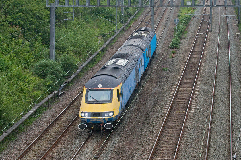 43423 & 43467, 07.29 Wembley Yard-King's Norton Plant (0Z45, 35E), Hyde Road bridge 
 The rapid progress of the 0Z45 07.29 Wembley Yard to King's Norton very nearly caught me out with my arrival at Roade's Hyde Road bridge some minute or so before the passage of the train! A very faded and weather-worn 43423 leads 43467 as they make their way back to their base in the southwestern suburbs of Birmingham. Both of these HST power cars are former Grand Central examples that spent their last couple of years working for East Midlands Railways hence their faded blue livery that I am sure will soon be replaced by Railadventure's rather more striking paint scheme. 
 Keywords: 43423 43467 07.29 Wembley Yard-King's Norton Plant 0Z45 Hyde Road bridge HST