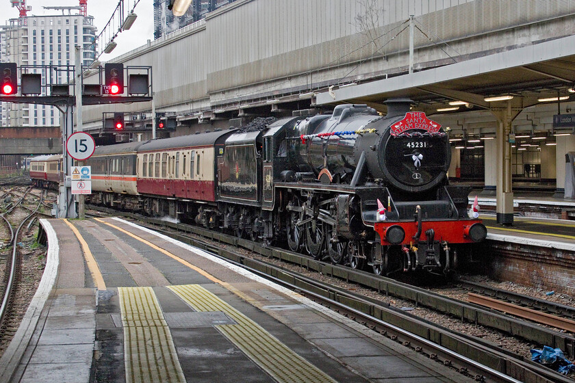 45231, returning Santa Steam Express, 09.26 London Victoria-London Victoria (1Z31, 7L), London Victoria station 
 The Christmas season is a busy and lucrative time for charter operators with this day at London's Victoria station no exception. Having photographed the Belmond Pullman service one of a series of Santa Steam Express charters arrives two minutes later. Suitably decked out in tinsel and with Santas disguising the running lights 45231 (formally LMS 5231) 'The Sherwood Forester' eases extremely slowly into Victoria station's platform seven leading the circular service that seemed full of groups of children. I was surprised that there was just one other enthusiast present to witness the arrival of the train with him suitable attired wearing an official Victoria pass on a lanyard with me having to resort to tapping in to gain access to the platform and even then feeling that I was going to be asked to leave at any moment; what has our hobby come to? 
 Keywords: 45231 Santa Steam Express 09.26 London Victoria-London Victoria 1Z31 London Victoria station The Sherwood Forester