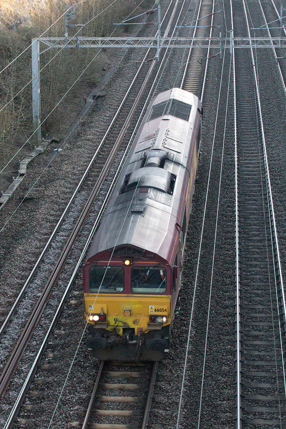 66054, 12.08 Wembley-DIRFT LE (0M45), Roade Cutting 
 Still wearing its EWS colours, 66054 passes light engine through Roade Cutting as the 0M45 12.08 Wembley to Daventry railfreight terminal. On Realtime Trains, this move was shown as starting from Dollands Moor so obviously something changed. I am not sure what service it worked back later. 
 Keywords: 66054 12.08 Wembley-DIRFT 0M45 Roade Cutting