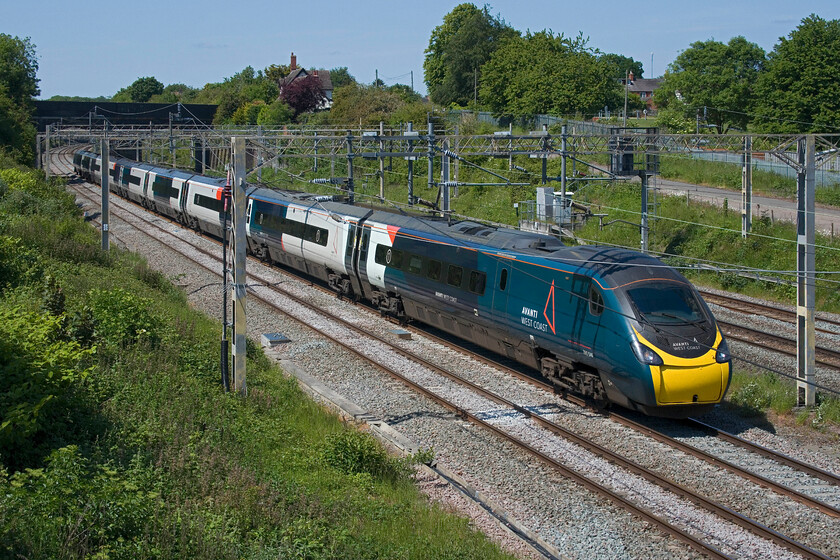 390046, VT 13.47 Birmingham New Street-London Euston (1B44, 6L), site of Roade station 
 Under glorious clear blue skies, 390046 passes the site of Roade's former station working AWC's 13.47 Birmingham New Street to Euston service. 
 Keywords: 390046 13.47 Birmingham New Street-London Euston 1B44 site of Roade station AWC Avati West Coast Pendolino