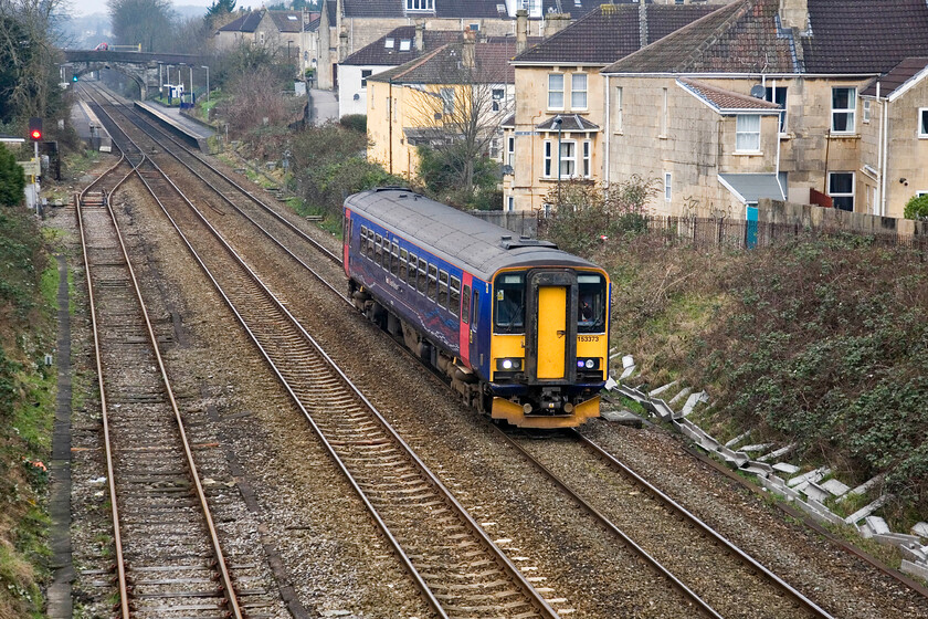 153373, 09.05 Bristol Temple Meads-Westbury, Oldfield Park, Brougham Heyes bridge 
 Having just left Oldfield Park station, seen in the background, 153373 picks up speed working the 09.05 Bristol to Westbury all stations service. First Great Western retains a significant number of these single-car units converted from two-car Class 155 sets by BR in the early 1990s. They have proved to be useful particularly deep in the West Country on their Devon and Cornish branch lines. 
 Keywords: 153373 09.05 Bristol Temple Meads-Westbury Oldfield Park Brougham Heyes bridge FGW